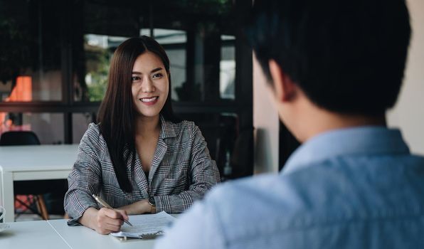 Employer or recruiter reading a resume during about colloquy his profile of candidate, employer conducting a job interview, manager resource employment and recruitment concept
