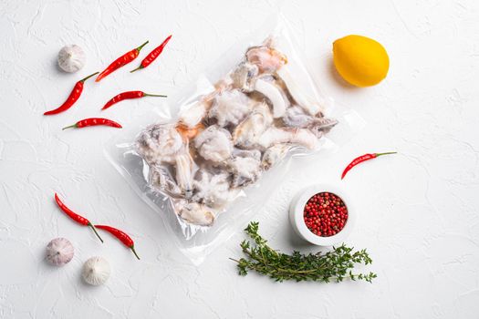 Frozen seafood pack set, on white stone table background, top view flat lay