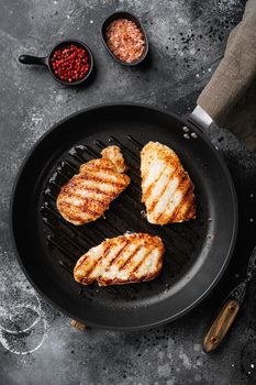 Fried schnitzel, on black dark stone table background, top view flat lay