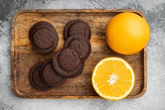 Cakes sweet cookies with orange, chocolate and coffee set, on gray background, top view flat lay