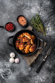Golden chicken nuggets frying in hot oil, on black dark stone table background, top view flat lay, with copy space for text