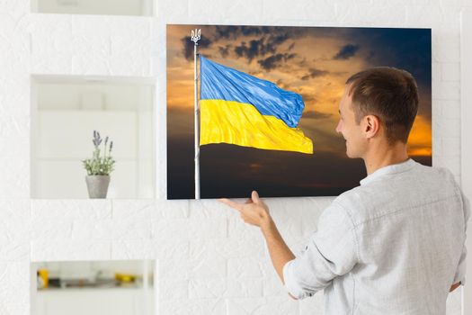 Blue and yellow flag of Ukraine paints on a canvas, national flag of Ukraine.