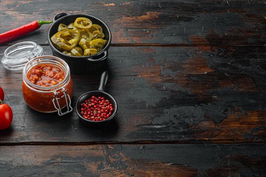 Ingredients for making tomato salsa sauce, on old dark wooden table background with copy space for text
