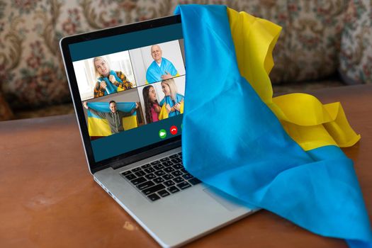 laptop near the ukraine flag. online conference.