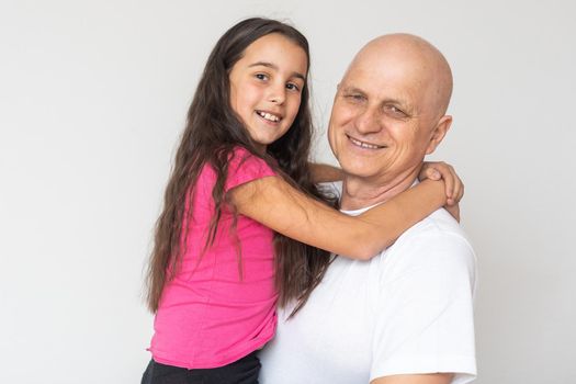 Girl embracing grand father at home
