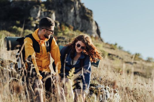 Two Young Travelers Man and Woman Made a Stop to Rest During Their Hiking on Top of Hill