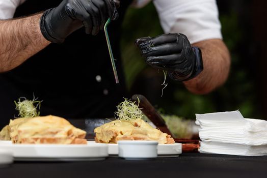 Francesinha, traditional Portuguese sandwich originally from Porto. National cuisine concept. the chef prepares a dish at restaurant.