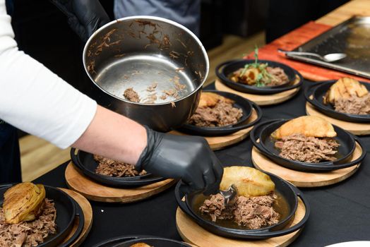 the chef prepares in a restaurant tasty Swiss dish with venison and cabbage .