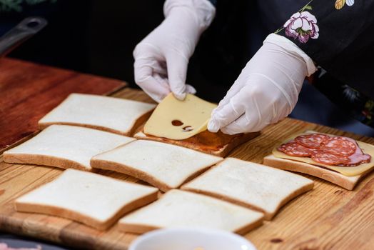 Francesinha, traditional Portuguese sandwich originally from Porto. National cuisine concept. the chef prepares a dish at restaurant.