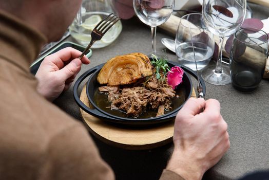 Plate of tasty Swiss dish with venison and cabbage served with herbs.