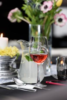 Glass of red wine on a served table in a restaurant.