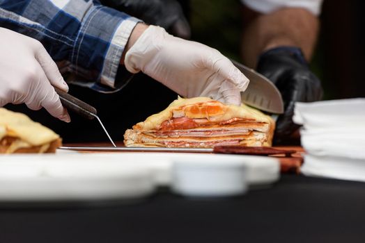 Francesinha, traditional Portuguese sandwich originally from Porto. National cuisine concept. the chef prepares a dish at restaurant.