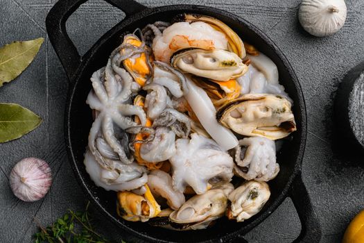 Fresh seafood arrangement mussels, squid octopus set, on gray stone table background, top view flat lay