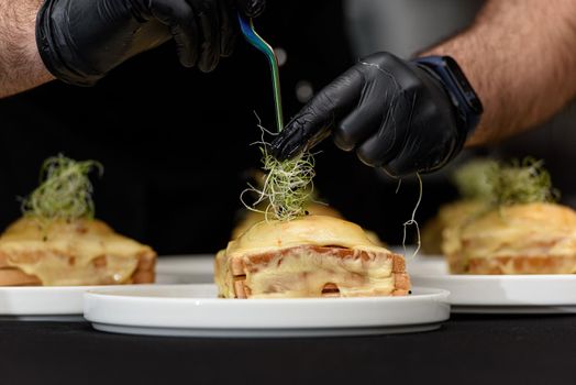 Francesinha, traditional Portuguese sandwich originally from Porto. National cuisine concept. the chef prepares a dish at restaurant.