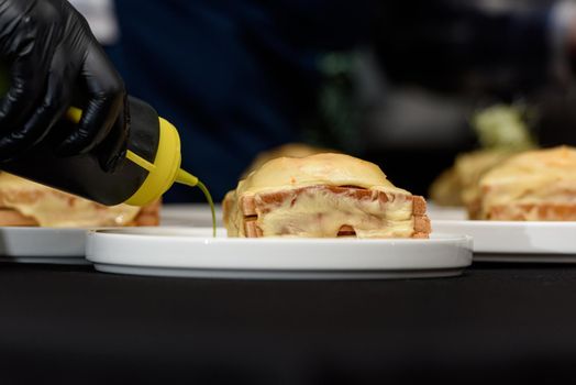 Francesinha, traditional Portuguese sandwich originally from Porto. National cuisine concept. the chef prepares a dish at restaurant.