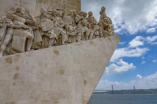 LISBON, PORTUGAL - APRIL 4, 2018: Monumento aos Descobrimentos with 25th april bridge in the background in Lisbon, Portugal