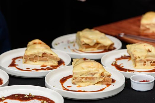 Francesinha, traditional Portuguese sandwich originally from Porto. National cuisine concept. the chef prepares a dish at restaurant.