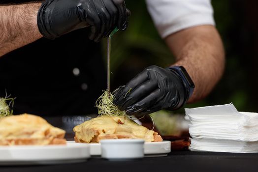 Francesinha, traditional Portuguese sandwich originally from Porto. National cuisine concept. the chef prepares a dish at restaurant.