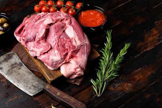 Raw meat products set, with ingredients and herbs, on old dark wooden table background, with copy space for text