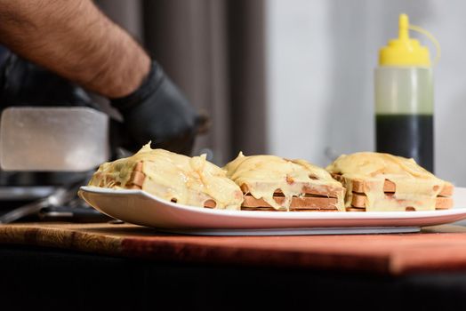 Francesinha, traditional Portuguese sandwich originally from Porto. National cuisine concept. the chef prepares a dish at restaurant.