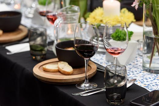 Glass of red wine on a served table in a restaurant.