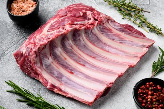 Raw meat rib rack set, on gray stone table background