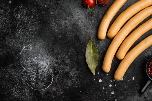 Fresh boiled Wiener sausages set, on black dark stone table background, top view flat lay, with copy space for text