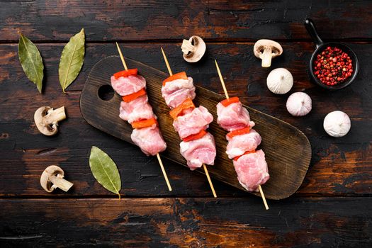 Uncooked Raw meat Chopsticks set, top view flat lay, on old dark wooden table background