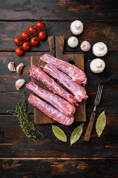 Raw chicken neck set, on old dark wooden table background, top view flat lay