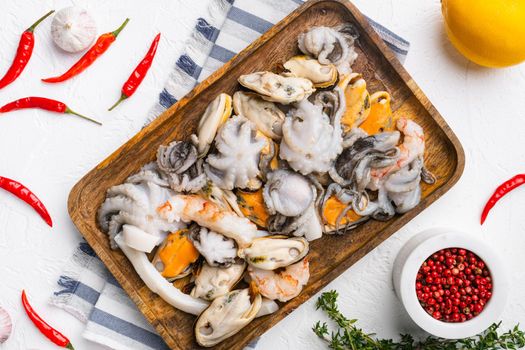 Seafood board with shrimp, squid mussel and octopus set, on white stone table background, top view flat lay