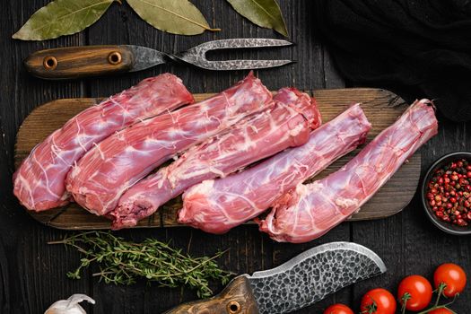 Bird chicken giblets gizzards stomachs set, on black wooden table background, top view flat lay