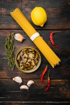 Pasta with mussels raw ingredients set, on old dark wooden table background, top view flat lay