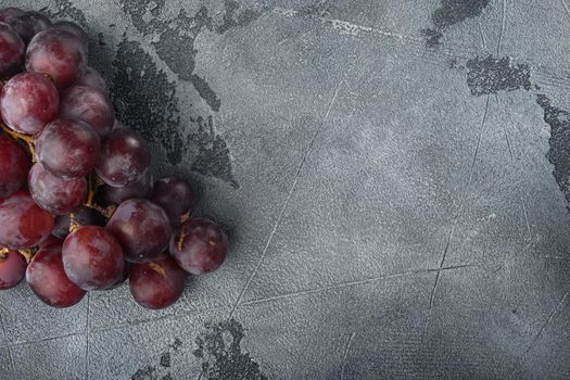 Ripe grape set, dark red fruits, on gray stone background, with copy space for text