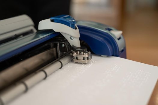 Close-up of a braille code printing machine