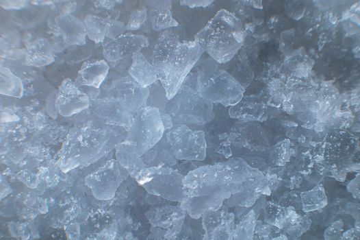 Coarse white iodized salt. Detailed background texture Macro close-up. Salt crystals of different sizes.