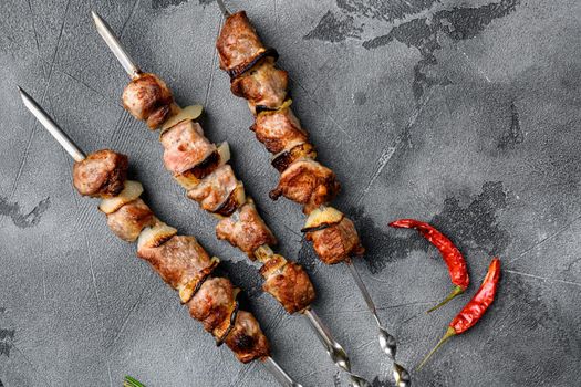 Grilled kebab set, on gray stone table background, top view flat lay, with copy space for text