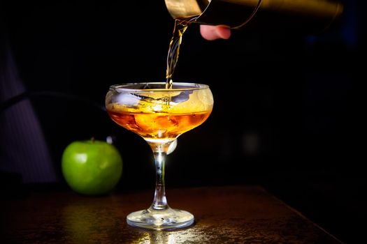 Red cocktail with lemon slice and Apple