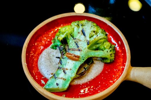 Broccoli grilled with sauce lying on a plate