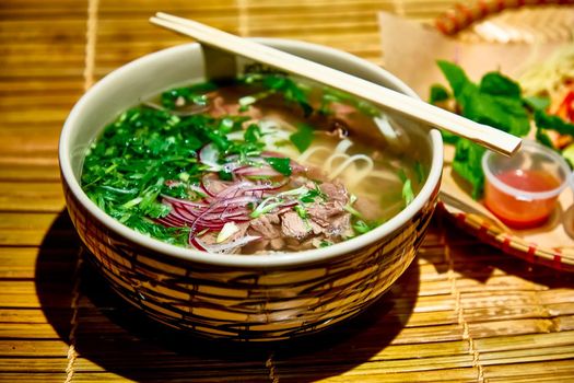 Traditional Vietnamese soup, Pho Bo in a large bowl.