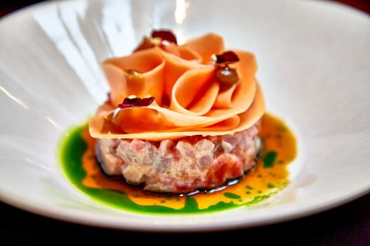 Beef tartare decorated with carrot slices