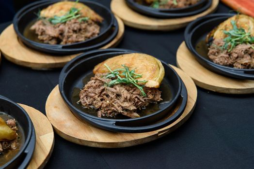 Plate of tasty Swiss dish with venison and cabbage served with herbs.