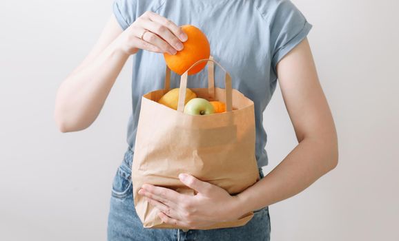 Delivery healthy food background. Vegan vegetarian food in paper bag vegetables and fruits on white, copy space, banner.Grocery shopping food supermarket and clean vegan eating concept.