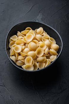 Semolina pasta dried, on black background