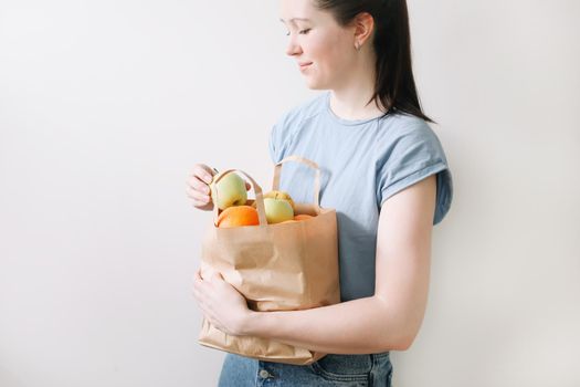 Delivery healthy food background. Vegan vegetarian food in paper bag vegetables and fruits on white, copy space, banner.Grocery shopping food supermarket and clean vegan eating concept.