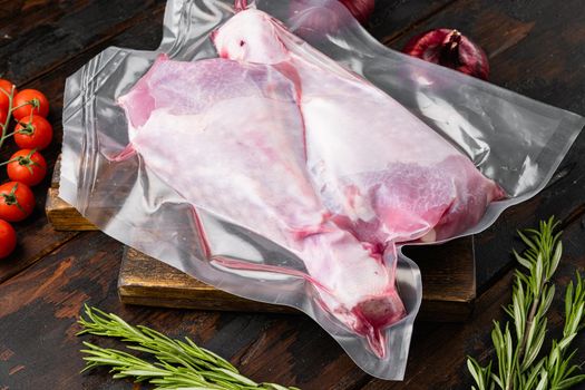 Turkey thigh in sealed plastic pack set, on old dark wooden table background