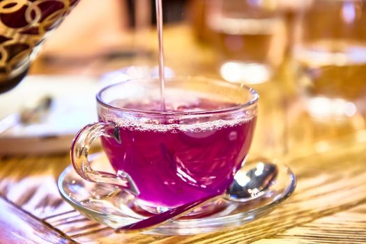 Fruit lilac tea with lavender in a glass Cup.