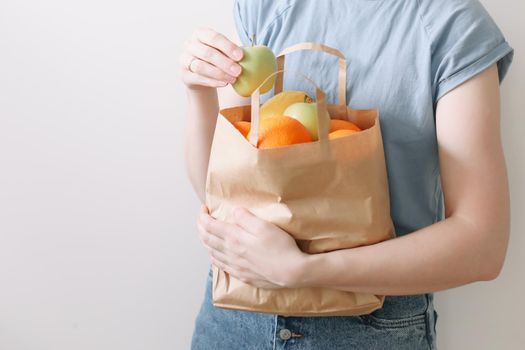 Delivery healthy food background. Vegan vegetarian food in paper bag vegetables and fruits on white, copy space, banner.Grocery shopping food supermarket and clean vegan eating concept.