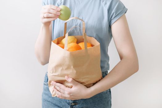 Delivery healthy food background. Vegan vegetarian food in paper bag vegetables and fruits on white, copy space, banner.Grocery shopping food supermarket and clean vegan eating concept.