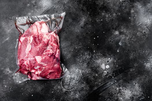 Lamb meat pack ready for cooking set, on black dark stone table background, top view flat lay, with copy space for text