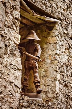 Metal statue of a fireman in a window opening 